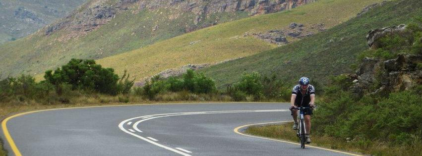 Cyclist riding a mountain switchback road